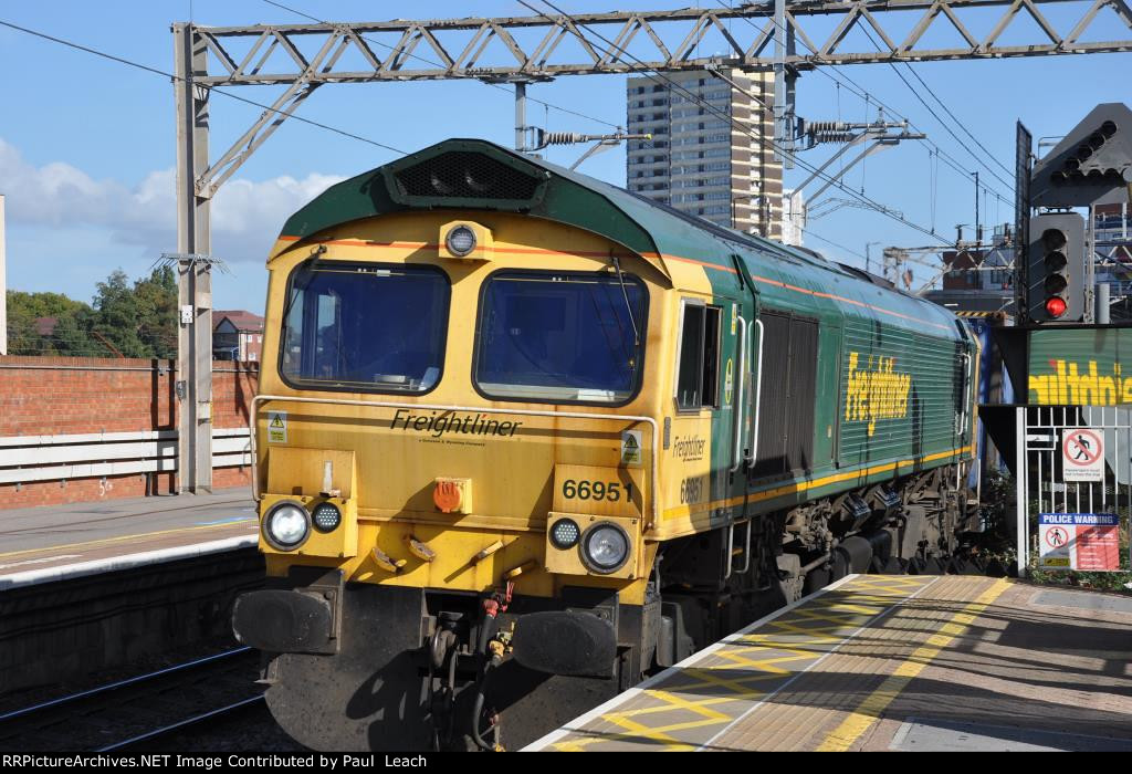 Inbound intermodal trails a Class 66 through the station